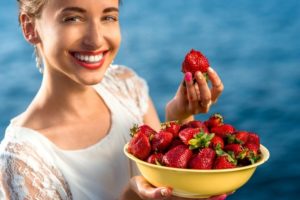 woman eating strawberries