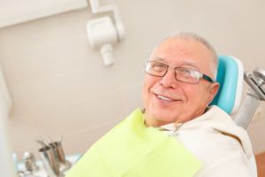 older man smiling in dentist chair