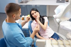 Woman at dentist holding jaw